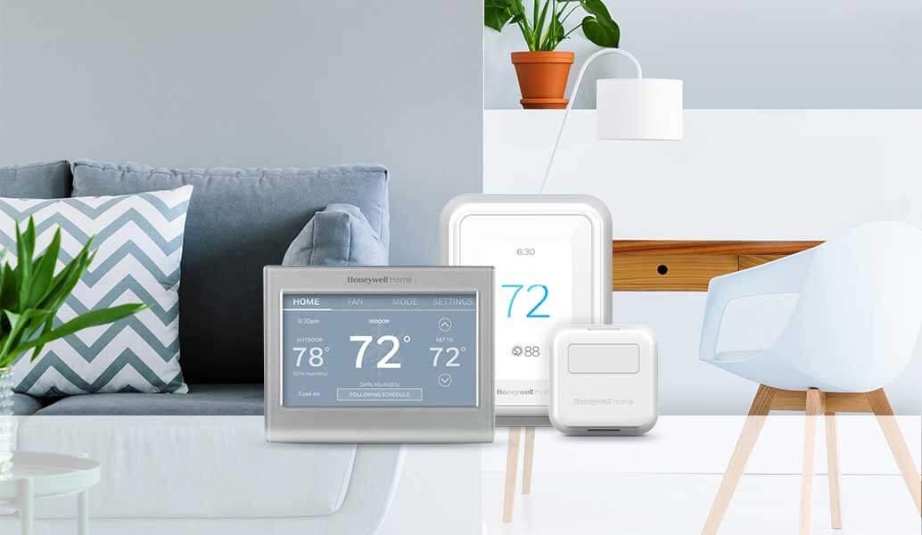 A cozy living room with Smart Thermostat products in the foreground.