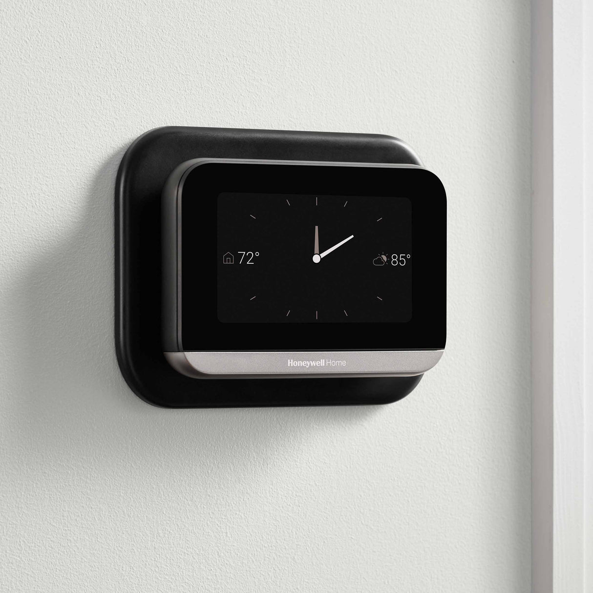 Thermostat Cover Plate Kit Black with thermostat installed in room with clock