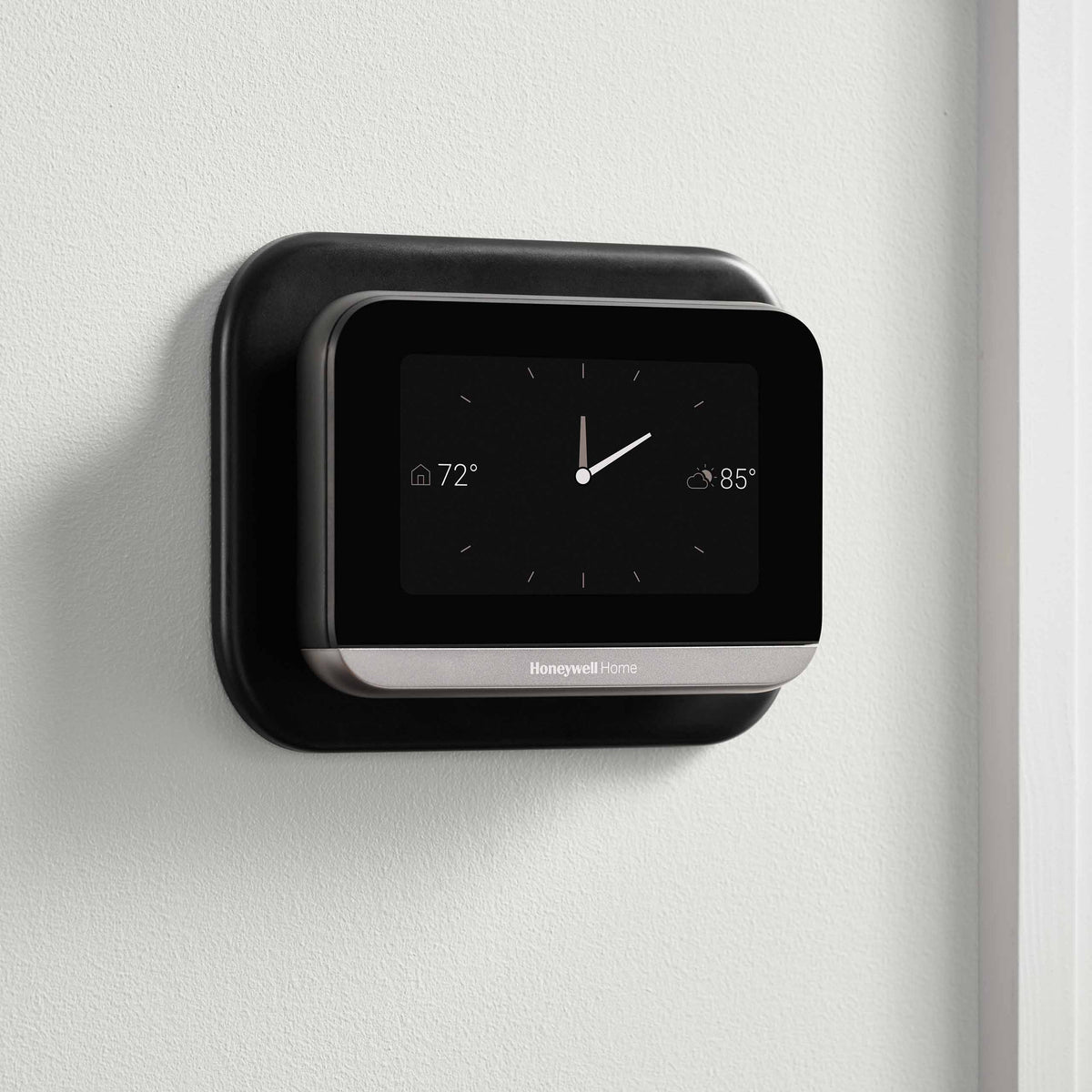 Thermostat Cover Plate Kit Black with thermostat installed in room with clock