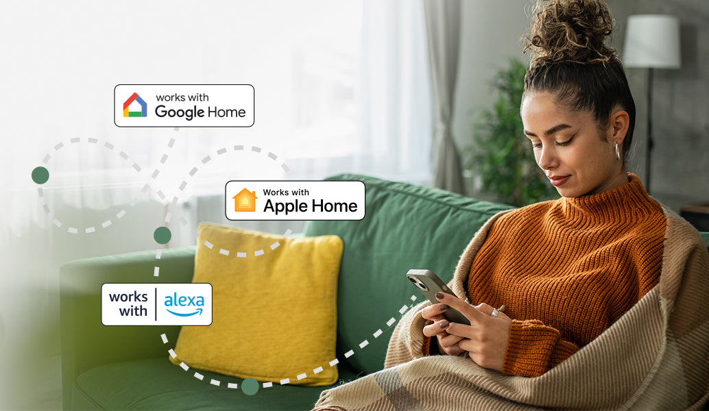 Woman using a smartphone with connectivity logos for Google Home, Apple Home, and Amazon Alexa in a living room setting.