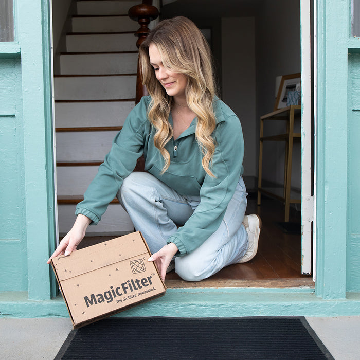 A woman receives a new air filter delivered to her home.