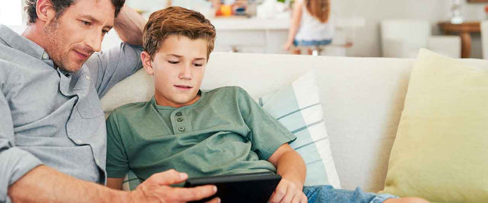 Father and son relaxing on couch